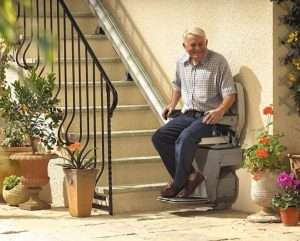 old man sitting on their stairlift