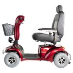 Side view of Merits Pioneer 10 heavy-duty mobility scooter in red with high-back captain’s seat and front basket