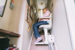 Senior woman using automatic stair lift